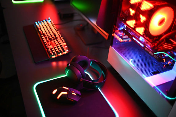 A computer setup with a keyboard, mouse, and headphones, representing a cozy and functional couples gaming setup for shared gaming experiences.