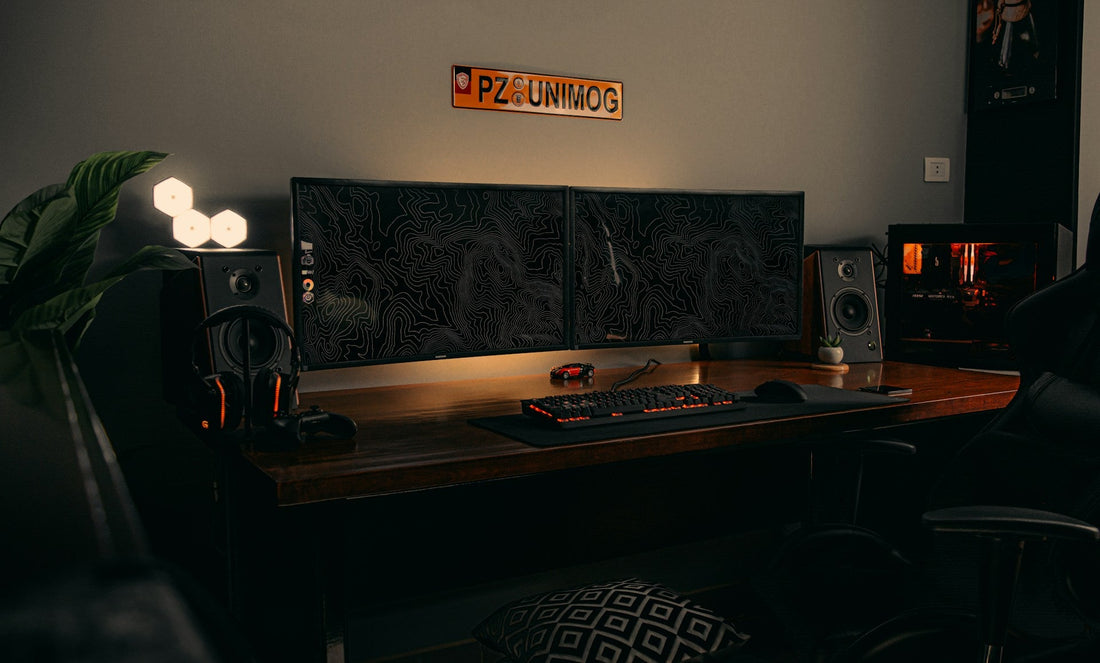 Black flat-screen computer monitor on a brown wooden desk, showcasing an essential element to set up a gaming room with a clean and organized layout.